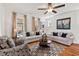 Comfortable living room with hardwood floors, ceiling fan, and ample natural light at 563 Great Ridge Parkway, Chapel Hill, NC 27516