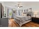 Serene main bedroom boasts hardwood floors, decorative art, and bright windows at 563 Great Ridge Parkway, Chapel Hill, NC 27516