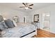 Spacious main bedroom with hardwood floors, stylish furnishings, and a ceiling fan at 563 Great Ridge Parkway, Chapel Hill, NC 27516