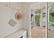 Inviting mud room with a bench, coat hooks, and access to a screened-in porch with outdoor views at 563 Great Ridge Parkway, Chapel Hill, NC 27516