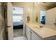 Bright bathroom with white vanity; doorway provides view of a bedroom at 5710 Corbon Crest Ln, Raleigh, NC 27612