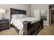 Large, carpeted bedroom features a full-size bed with large bedside lamps at 5710 Corbon Crest Ln, Raleigh, NC 27612