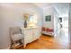 Entryway features hardwood floors, seating, and a white cabinet with decorative items at 5710 Corbon Crest Ln, Raleigh, NC 27612