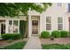 Charming two-story townhome with a well-maintained lawn and inviting front entrance at 5710 Corbon Crest Ln, Raleigh, NC 27612
