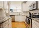 Kitchen with granite countertops, modern appliances, and hardwood floors at 5710 Corbon Crest Ln, Raleigh, NC 27612