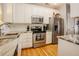This kitchen features white cabinets, granite countertops and stainless steel appliances at 5710 Corbon Crest Ln, Raleigh, NC 27612