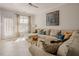 A bright living room with a sectional sofa, fireplace, and large windows at 5710 Corbon Crest Ln, Raleigh, NC 27612