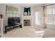Cozy living room featuring a fireplace and natural light through the window at 5710 Corbon Crest Ln, Raleigh, NC 27612