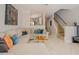 Cozy living room featuring staircase, sectional sofa, and an open view to the kitchen at 5710 Corbon Crest Ln, Raleigh, NC 27612
