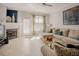 Bright living room featuring natural light, a fireplace, and a comfortable sectional sofa at 5710 Corbon Crest Ln, Raleigh, NC 27612