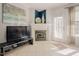 Cozy living space with a fireplace, tile floors, and a door leading to the backyard at 5710 Corbon Crest Ln, Raleigh, NC 27612