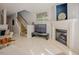 Living room with staircase, fireplace, television, and tile flooring at 5710 Corbon Crest Ln, Raleigh, NC 27612