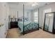 Bedroom featuring a canopy bed frame, bedside table, and a large decorative mirror at 5710 Corbon Crest Ln, Raleigh, NC 27612