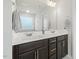 Bathroom featuring a dual sink vanity with black cabinets and a large mirror at 575 Dawley Dr, Fuquay Varina, NC 27526