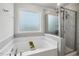 Bathroom featuring a tiled shower with glass doors, a garden tub, and neutral paint at 575 Dawley Dr, Fuquay Varina, NC 27526