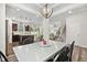 Open dining room features a modern chandelier, view of the kitchen and staircase at 575 Dawley Dr, Fuquay Varina, NC 27526