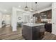Contemporary kitchen featuring a kitchen island, pendant lighting, stainless steel appliances, and an adjacent dining area at 575 Dawley Dr, Fuquay Varina, NC 27526