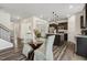 Open-concept kitchen with a kitchen island, dining area, and views into the adjacent living spaces at 575 Dawley Dr, Fuquay Varina, NC 27526