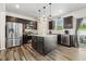 Modern kitchen with stainless steel appliances, granite countertops, kitchen island, and dark cabinetry at 575 Dawley Dr, Fuquay Varina, NC 27526