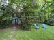 Lush backyard featuring a shed, seating, and mature trees for private outdoor enjoyment at 5817 Wintergreen Dr, Raleigh, NC 27609