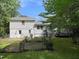 Exterior view of the home's backyard, surrounded by mature trees and greenery at 5817 Wintergreen Dr, Raleigh, NC 27609