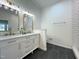 Stylish bathroom with double vanity, modern fixtures, subway tile and dark floors at 5817 Wintergreen Dr, Raleigh, NC 27609