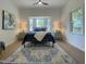 Inviting bedroom boasts a large bay window, a ceiling fan, and hardwood floors at 5817 Wintergreen Dr, Raleigh, NC 27609