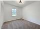 Neutral bedroom with a window providing natural light and a spacious closet at 5817 Wintergreen Dr, Raleigh, NC 27609