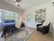 Cozy bedroom features a bay window, chair, and hardwood floors at 5817 Wintergreen Dr, Raleigh, NC 27609