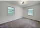 Carpeted bedroom featuring a ceiling light and two windows that bring in natural light at 5817 Wintergreen Dr, Raleigh, NC 27609