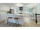 Bright kitchen with white cabinetry, quartz countertops, and modern island seating at 5817 Wintergreen Dr, Raleigh, NC 27609