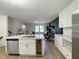 Modern kitchen featuring stainless steel appliances, a wine cooler, and seamless open floorplan into the living room at 5817 Wintergreen Dr, Raleigh, NC 27609