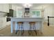 Modern kitchen featuring a central island with seating and stainless steel appliances with hardwood floors at 5817 Wintergreen Dr, Raleigh, NC 27609