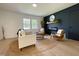 Cozy living room featuring a decorative accent wall, fireplace, and neutral furniture at 5817 Wintergreen Dr, Raleigh, NC 27609