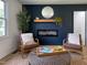 Relaxing space with two armchairs, a modern fireplace and a wicker table on an area rug at 5817 Wintergreen Dr, Raleigh, NC 27609