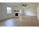 Spacious living room with a fireplace, hardwood floors, and plenty of natural light at 5817 Wintergreen Dr, Raleigh, NC 27609