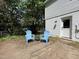 Concrete patio with two blue Adirondack chairs, next to the house at 5817 Wintergreen Dr, Raleigh, NC 27609