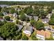 An aerial view displays homes in a suburban neighborhood, bordered by green foliage and open spaces at 620 Hanska Way, Raleigh, NC 27610