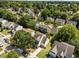 This aerial view captures the home within a neighborhood filled with lush greenery and mature trees at 620 Hanska Way, Raleigh, NC 27610