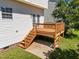 A charming back deck and stairs are featured in this home's outdoor living space at 620 Hanska Way, Raleigh, NC 27610