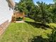 A lush backyard features a well-kept lawn and a wooden deck, offering ample space at 620 Hanska Way, Raleigh, NC 27610