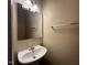 Bathroom featuring a sink, mirror, towel bar, and overhead lighting at 620 Hanska Way, Raleigh, NC 27610