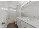 Bright bathroom featuring double sinks, white cabinetry, and a tub at 620 Hanska Way, Raleigh, NC 27610