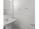 Bathroom featuring a pedestal sink, mirror, and towel racks at 620 Hanska Way, Raleigh, NC 27610