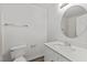 Bathroom features a round mirror over white vanity and toilet at 620 Hanska Way, Raleigh, NC 27610