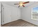 Bedroom with ceiling fan, closet, and natural light from the window at 620 Hanska Way, Raleigh, NC 27610