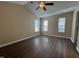 Bedroom featuring hard surface floors, a ceiling fan, and three windows at 620 Hanska Way, Raleigh, NC 27610
