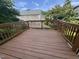 Spacious wood deck area with a railing overlooking lush trees and a neighboring home at 620 Hanska Way, Raleigh, NC 27610