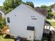 Back of home features an attached wood deck and a clean white exterior at 620 Hanska Way, Raleigh, NC 27610