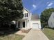 Charming two-story home with white siding, black shutters, and attached one car garage at 620 Hanska Way, Raleigh, NC 27610